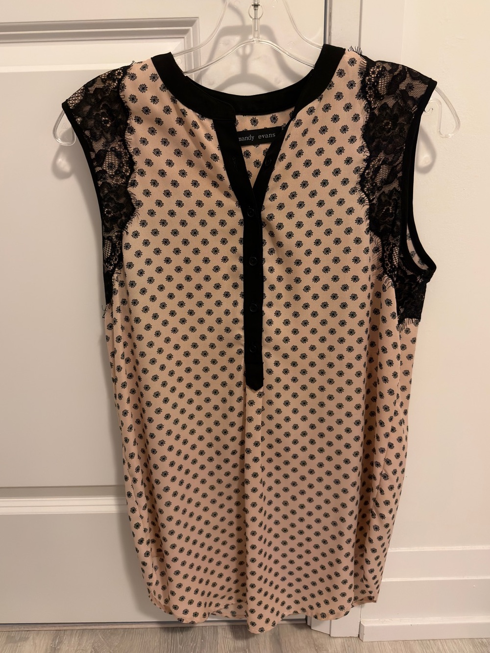 Sleeveless blush polka dot blouse with black lace trim